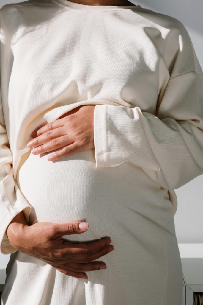 Pregnancy belly in white outfit