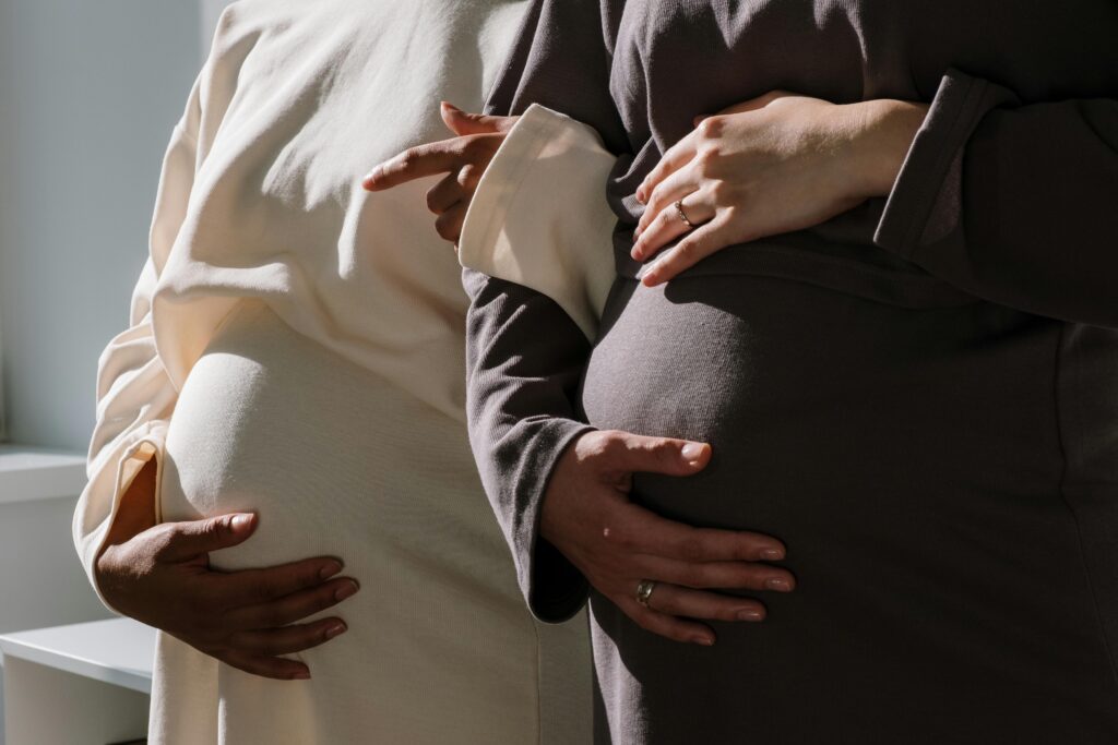 Pregnant bellies in neutral outfits